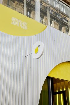 a building that has a yellow and white awning on the side of it's front