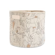 a white and brown fabric basket with animals printed on the front, along with an inner pocket for storage