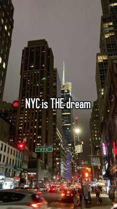 a city street filled with lots of traffic and tall buildings at night, with the words nyc is the dream above it