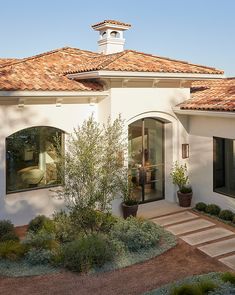 a white house with a red tiled roof