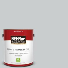 a can of behr premium plus paint and primer in one on a blue background