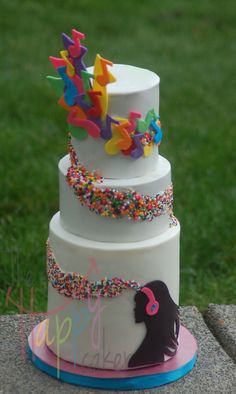 a three tiered cake with colorful sprinkles on it