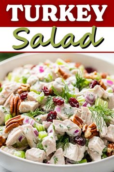 a white bowl filled with chicken salad and cranberries