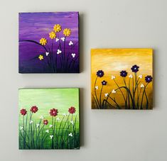 three paintings on canvass with flowers painted on them