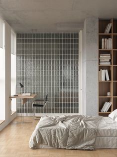 a bed sitting in a bedroom next to a book shelf