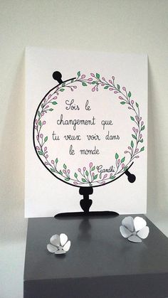 a card with some flowers on top of it and the words in french are placed next to each other