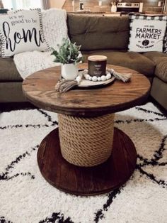 a living room with a couch, coffee table and rug on the floor in front of it