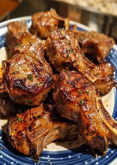 a plate full of cooked meat on a blue and white plate with sprinkles