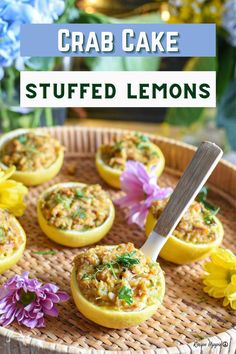 crab cake stuffed lemons on a wicker tray with purple flowers in the background