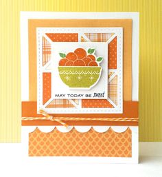 a close up of a card with a bowl of fruit on the front and an orange background