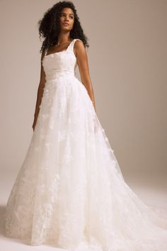 a woman in a wedding dress posing for the camera