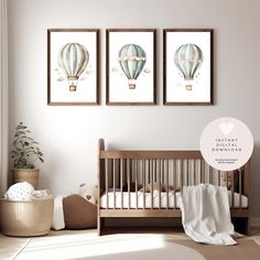 a baby's room with three hot air balloons on the wall