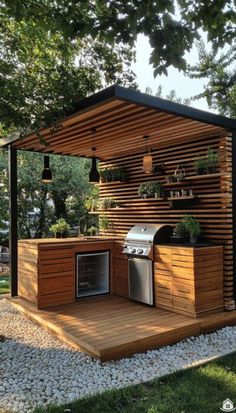 an outdoor kitchen is built into the side of a wooden structure with plants growing on it