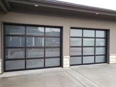 two garage doors are open in front of a building