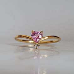 This 14K Pink Sapphire Heart ring makes for a perfect promise ring, or as a gift for your beloved. Nothing like saying "I love you" with this dainty beauty top with a natural white diamond. Perfect to wear alone or stacked with other ring bands. Available in 14k yellow gold, rose gold, and white gold. Pair it with our Siren Marquise ring or Winter Palace Marquise ring (as pictured) for the ultimate majestic look. This ring is designed and made in NYC. 14k solid gold band Natural pink heart sapph Sapphire Heart Ring, Sapphire Ring Designs, Pink Sapphire Diamond Ring, Cute Promise Rings, Heart Promise Rings, Ring Bands, Cute Engagement Rings, Sapphire Diamond Ring, Jewelry Lookbook