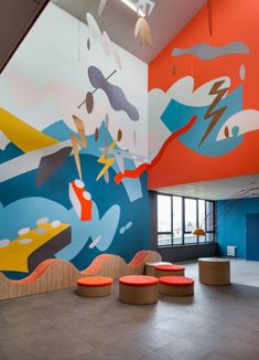 the interior of an office building with colorful murals on the wall