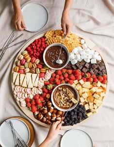 a platter filled with lots of different types of food on top of a table