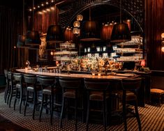 a dimly lit bar with lots of stools