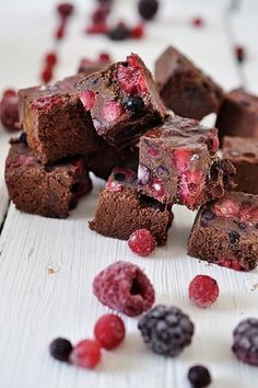 chocolate raspberry brownies cut in half and scattered with berries