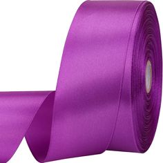 a roll of purple satin ribbon on a white background