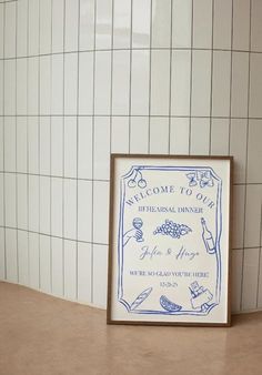 there is a framed sign on the counter in front of a tiled wall and floor