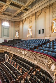 an empty auditorium filled with blue seats