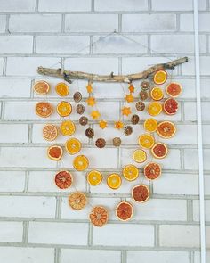 orange slices are arranged on a white brick wall