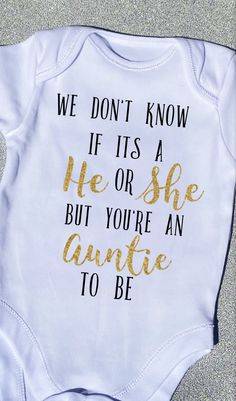 a white onesuit with gold lettering that says, we don't know if it's a he or she but you're grandparents to be