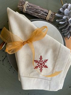 a napkin with an embroidered snowflake on it