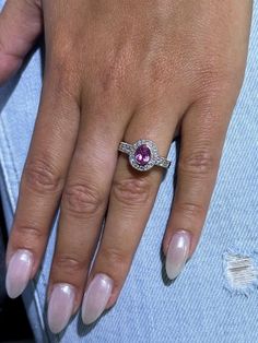 a close up of a person's hand with a ring on their finger and nails