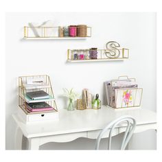 a white desk topped with two shelves filled with books and other office supplies next to a chair