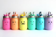 colorful painted mason jars with faces and pencils in them