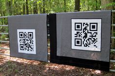 two black and white quilts with qr - code designs on them in the woods