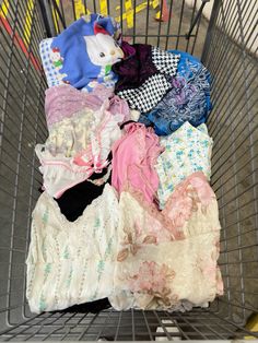 a shopping cart filled with lots of clothes