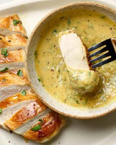 a spoon is being used to scoop chicken out of a bowl