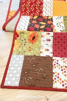 a quilted table runner made with patchwork fabric