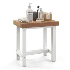 a wooden table topped with lots of bottles and soap dispensers on top of it