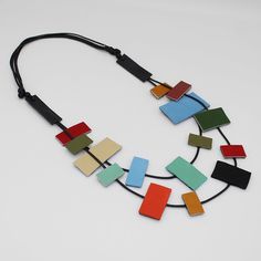 Make a statement with our Multi-Color Rowyn Leather Color Block Necklace! Featuring a unique double strand design adorned with rectangular leather beads and lightweight feel, this necklace is perfect for any occasion. The adjustable length ensures a comfortable fit, while the black wax cord adds a touch of edginess.  Adjustable length: 26"-32"  Beads: 1"-2"  Care Instructions: Remove jewelry when applying perfumes, creams, washing hands, etc. Do not store in direct sunlight. To restore color and shine, apply a drop of oil with a soft cloth. Leather Beads, Washing Hands, Necklace Big, Colorful Necklace, Paper Jewelry, Necklace Statement, Bead Leather, Colourful Necklace, Adjustable Necklace