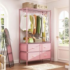 a pink closet with clothes hanging on it