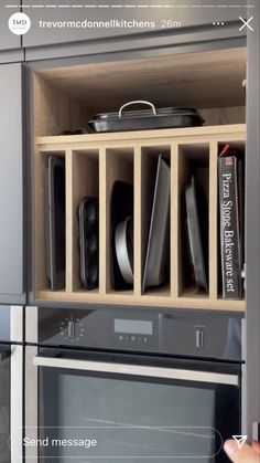 a kitchen cabinet filled with black and white dishes