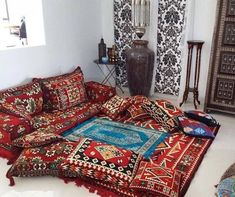 a room with many different rugs on the floor