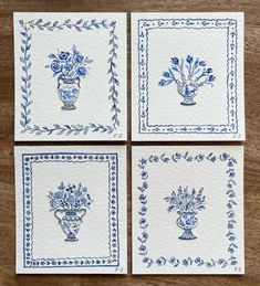 four blue and white cards with flowers in vases