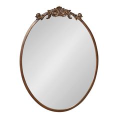 a round mirror with an ornate design on it