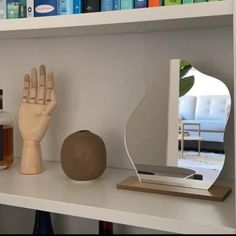 a wooden hand next to a bottle of booze on a shelf with the caption poshmark $ 23