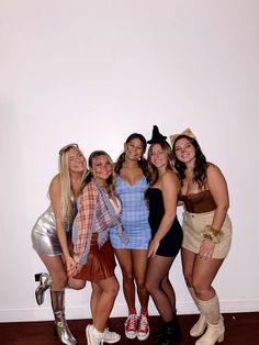 four women in costumes posing for the camera