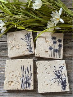 four pieces of tile with flowers on them