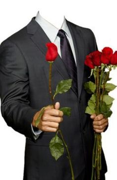 a man in a suit holding three roses