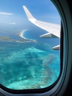 an airplane window looking out at the ocean