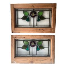 two stained glass windows with green leaves on them