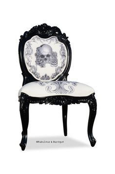 an ornate chair with a skull on it's back and white fabric seat cover